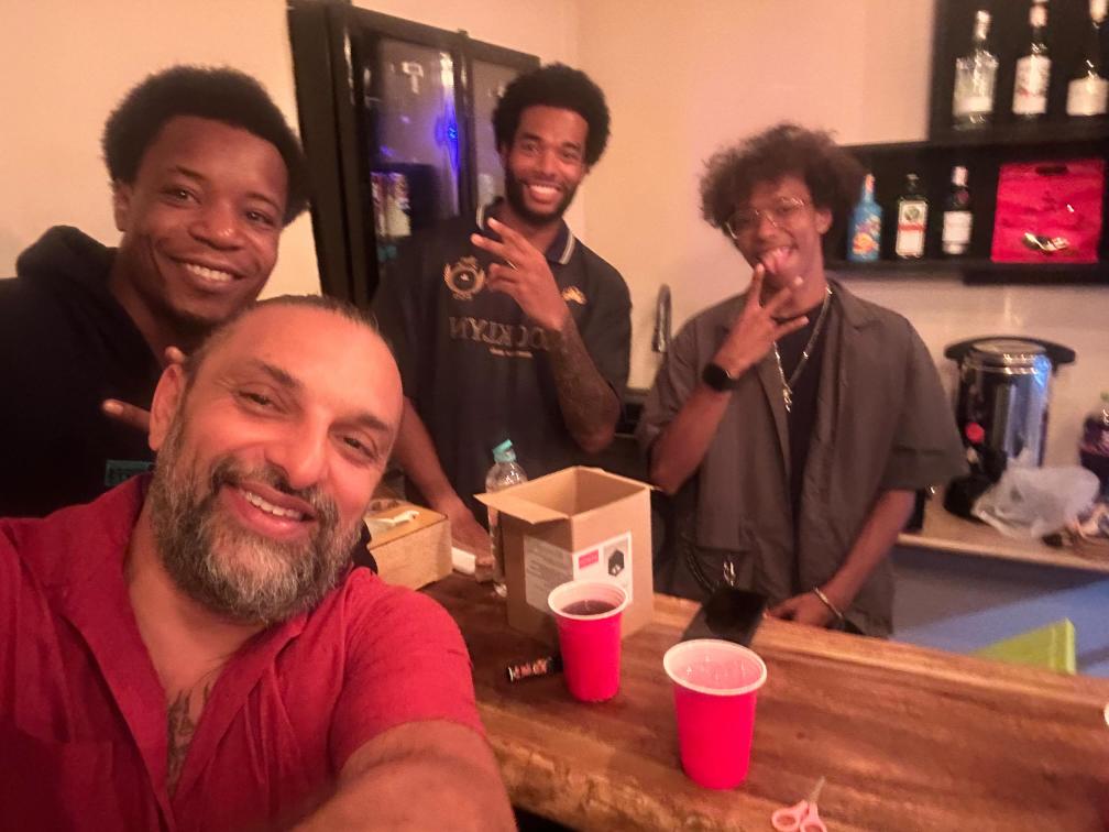 Vibe House owners and friends behind the bar